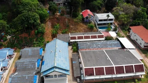 Flight over rooftops, colored houses, Phuket locals, old buildings, swimmingpool Stock Footage 247133633