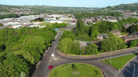 Flight over a roundabout UK surrounding by streets and Industrial Estates Stock Footage 243529431