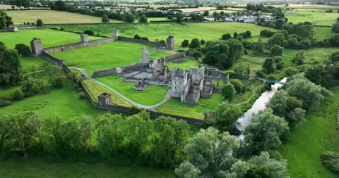 A flight over a ruined medieval castle in Kells Priory 4k Stock Footage 246772743