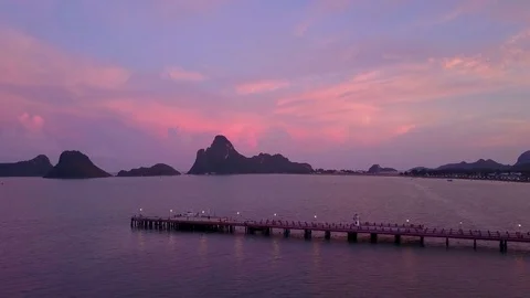 Flight over a sea bay at sunset Stock Footage
