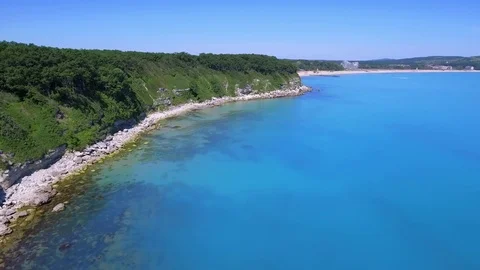 Flight over the sea coast with clear blue water Stock Footage 76788341