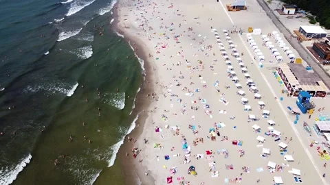 Flight over the sea coast with many tourists on the shore Stock Footage 178367190