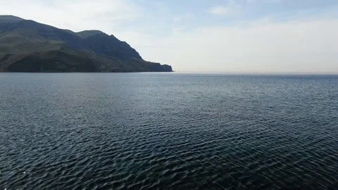 Flight over the sea in the mountainous coast Stock Footage 106208751