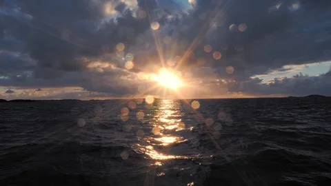 Flight over the sea, towards the bright yellow sun at sunset. Magnificent Stock Footage 88409122