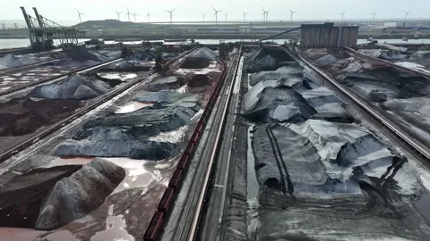 Flight over site of decommissioned coal power plant and wind turbines in distanc Stock Footage 276636106