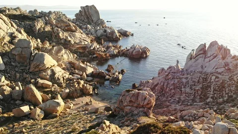 Flight over a small beach set by huge cliffs smoothed by the wind and the se Stock Footage 128841893