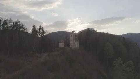 Flight over small chapel in the forest revealing amazing yellow red sun rays, 4k Stock Footage 74492852