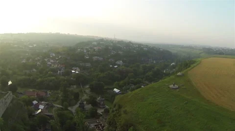 Flight over small city in  valley. Aerial shot Stockbeeldmateriaal 42139960