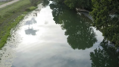 Flight over a small river next to a waterfall Видео 138530395