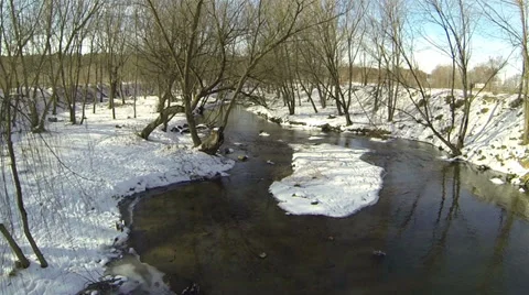 Flight over  small river in the winter wood. Aerial Stock Footage 34832248