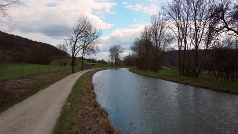 Flight over small stream close to trees and water 库存影片 151602820