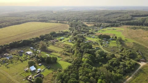 Flight over a small village, wild nature, morning hours Stock Footage 254066331