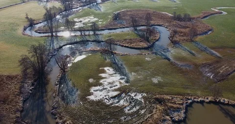 Flight over a small winding river 動画素材 124524722