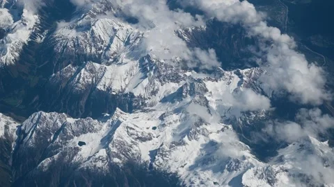 Flight over snow-capped mountains. View through airplane window Stock Footage 308958103