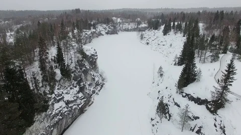 Flight over snow-covered canyon with frozen water Stock Footage 92852606