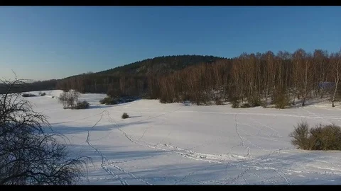 Flight over the snow-covered meadow Stock Footage 73150901