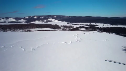 Flight over a snow-covered river Stock Footage 334555507