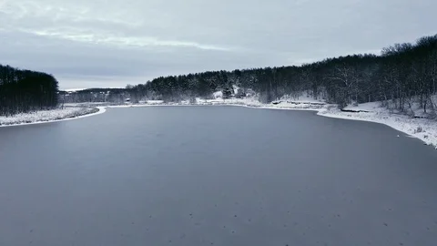 Flight over the snow forest and the frozen lake in the first snow Stock Footage 88205837