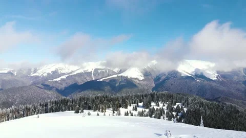 Flight over the snow surface in the mountains in winter Stock Footage 130853020