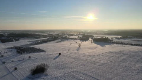 Flight over snowy agricultural fields in countryside in winter Video stock 146867672