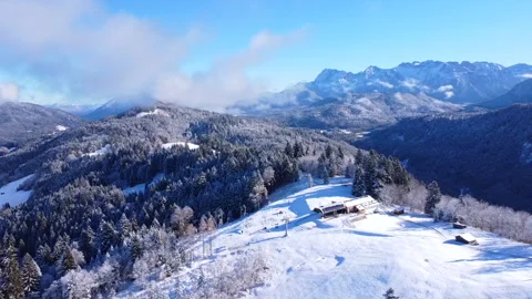 Flight Over Snowy Hill with Winter Mountains in the Background 2 Stock Footage 297621935
