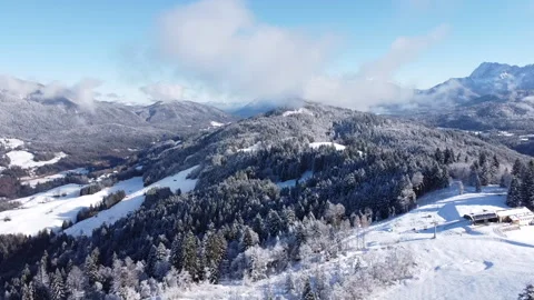 Flight Over Snowy Hill with Winter Mountains in the Background Stock Footage 297621939
