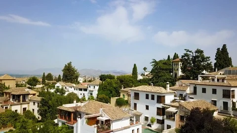Flight over Spanish Rooftops and Gardens in Granada (Graded) Stock Footage 85868079