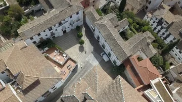 Flight over Spanish Rooftops in Granada with a Castle in the Distance (Ungraded) Stock Footage 85868228