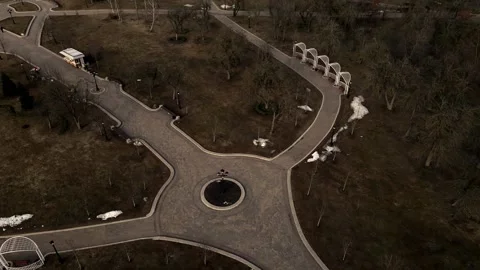 Flight over the spring city park. Walkways are visible. Patterns of park alleys. Stock Footage 150511212