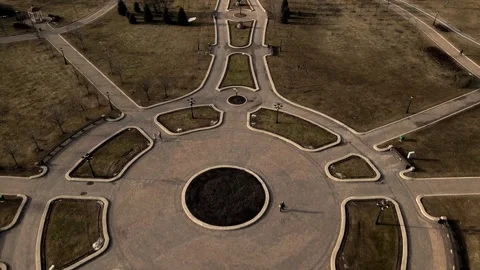 Flight over the spring city park. Walkways are visible. Patterns of park alleys. Stock Footage 150511221