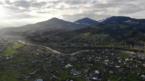 Flight over spring  mountain village with forest in sunset soft light. Stock Footage 119352473