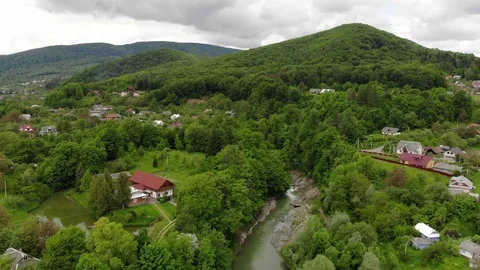Flight over spring mountain village with forest in sunrise soft light Stock Footage 121684448