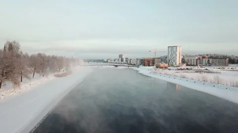 Flight over a steaming river and pedestrian bridge. Stock Footage 130781040