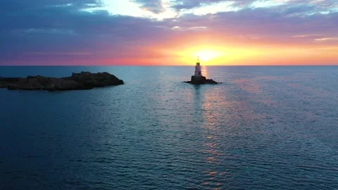 Flight over a sunny path to a lighthouse. Fishing boat with fishermen Stock Footage 197511213