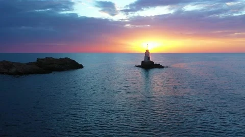 Flight over a sunny path to a lighthouse on an island and a sunrise. Ahtopol Stock Footage 199413309