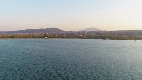 Flight over the surface of the lake towards the mountain Video stock 153028287