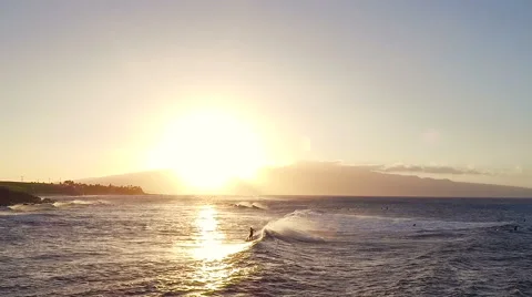 Flight Over Surfers Surfing Ocean Waves at Sunset. Amazing Sunset Aerial Shot Stock Footage 57253053