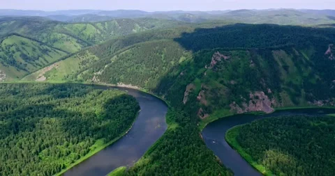 Flight over the taiga, the river flows among the mountains. Stock Footage 172103229