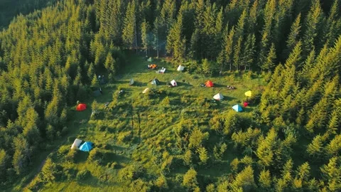 Flight over a tent camping group of tourists in the mountains at sunrise. Potato Stock Footage 157004126