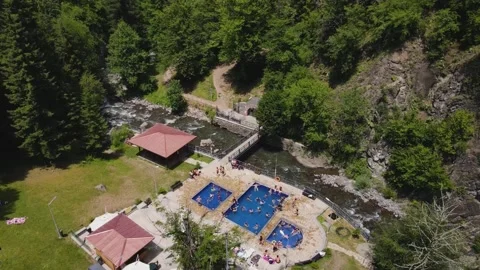 Flight over the termal pools of the Borjomi resort, people swim in pools Video stock 168678292