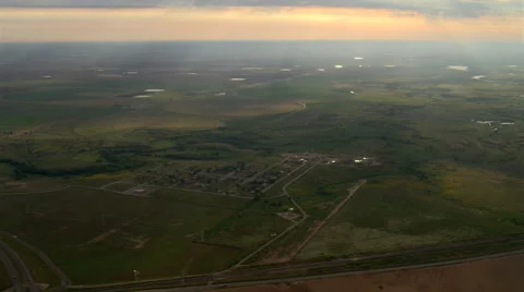 Flight over a Texas landscape where slanting evening rays sparkle on pools of Stock Footage 59334573