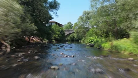 Flight Over Topolnitsa River Passing Under a Old Stone Bridge Bulgaria Stock Footage 321255107