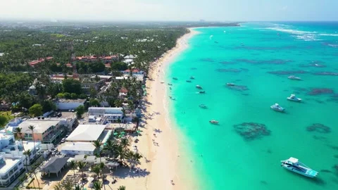 Flight over the tourist beach of Bavaro, Punta Cana on a bright sunny day Video stock 308023341