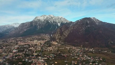 Flight over a town next to Alps in Northern Italy 스톡 동영상 76561344