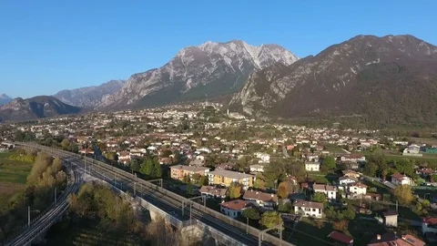 Flight over a town next to Alps in Northern Italy 스톡 동영상 76732163