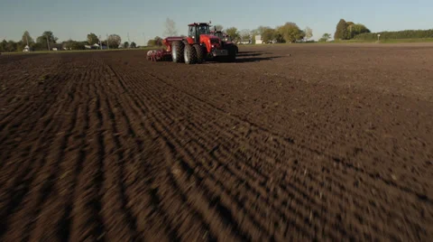 Flight over the tractor in the field stock footage aerial view Stock Footage 37800591