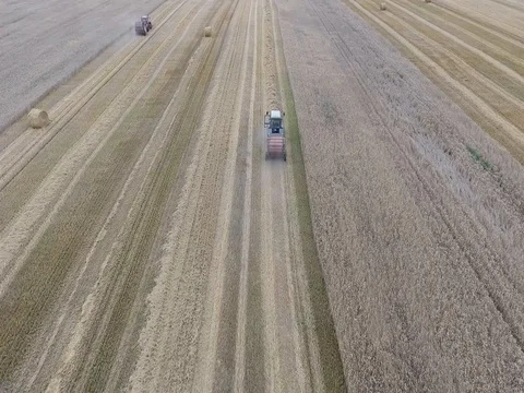 Flight over the tractor working in field Stock Footage 70349045