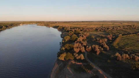 Flight over the trees near the river in the evening Stock Footage 93887348