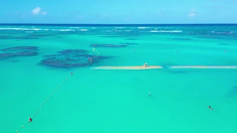 Flight over the turquoise sea surface within the buoy zone Vista Sol Punta Cana Stock Footage 307445993