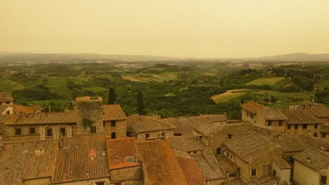 Flight over Tuscan town with hilly typical landscape that appears Video stock 319964049